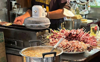 Skewers being grilled at a local eatery in Shinjuku, Tokyo during a guided food tour.