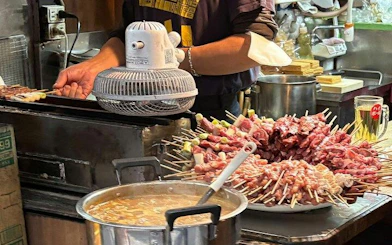 Skewers being grilled at a local eatery in Shinjuku, Tokyo during a guided food tour.