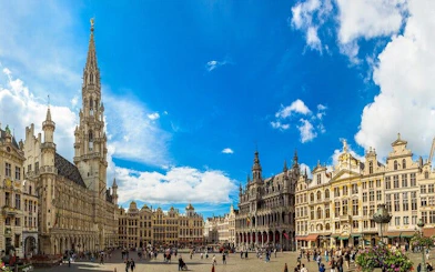 Grand Place in Brussels with historic buildings and tourists exploring the square.