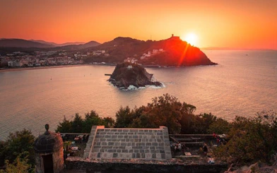 San Sebastian sunset view over La Concha Bay from a hilltop, featuring Santa Clara Island.