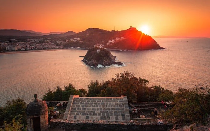 San Sebastian sunset view over La Concha Bay from a hilltop, featuring Santa Clara Island.