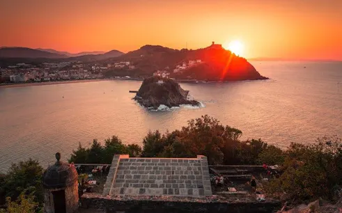 San Sebastian sunset view over La Concha Bay from a hilltop, featuring Santa Clara Island.