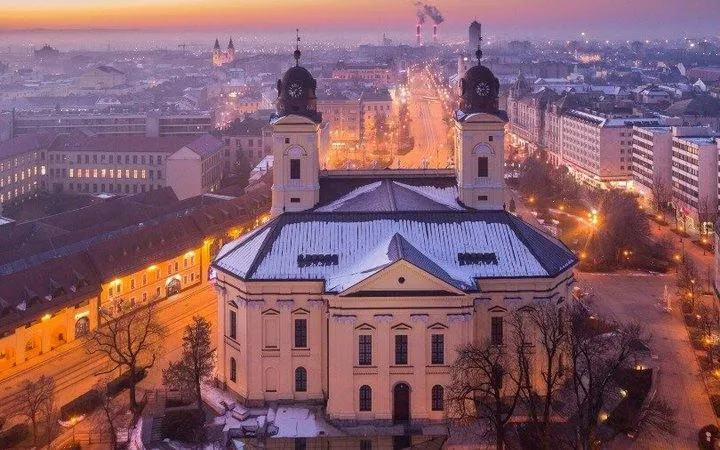 Reformed Great Church in Debrecen at dusk during self-guided audio walking tour.
