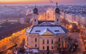 Reformed Great Church in Debrecen at dusk during self-guided audio walking tour.