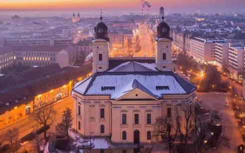 Reformed Great Church in Debrecen at dusk during self-guided audio walking tour.