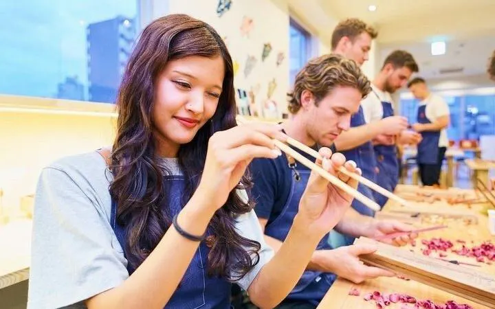 Participants crafting chopsticks at a workshop in Arashiyama, Kyoto.