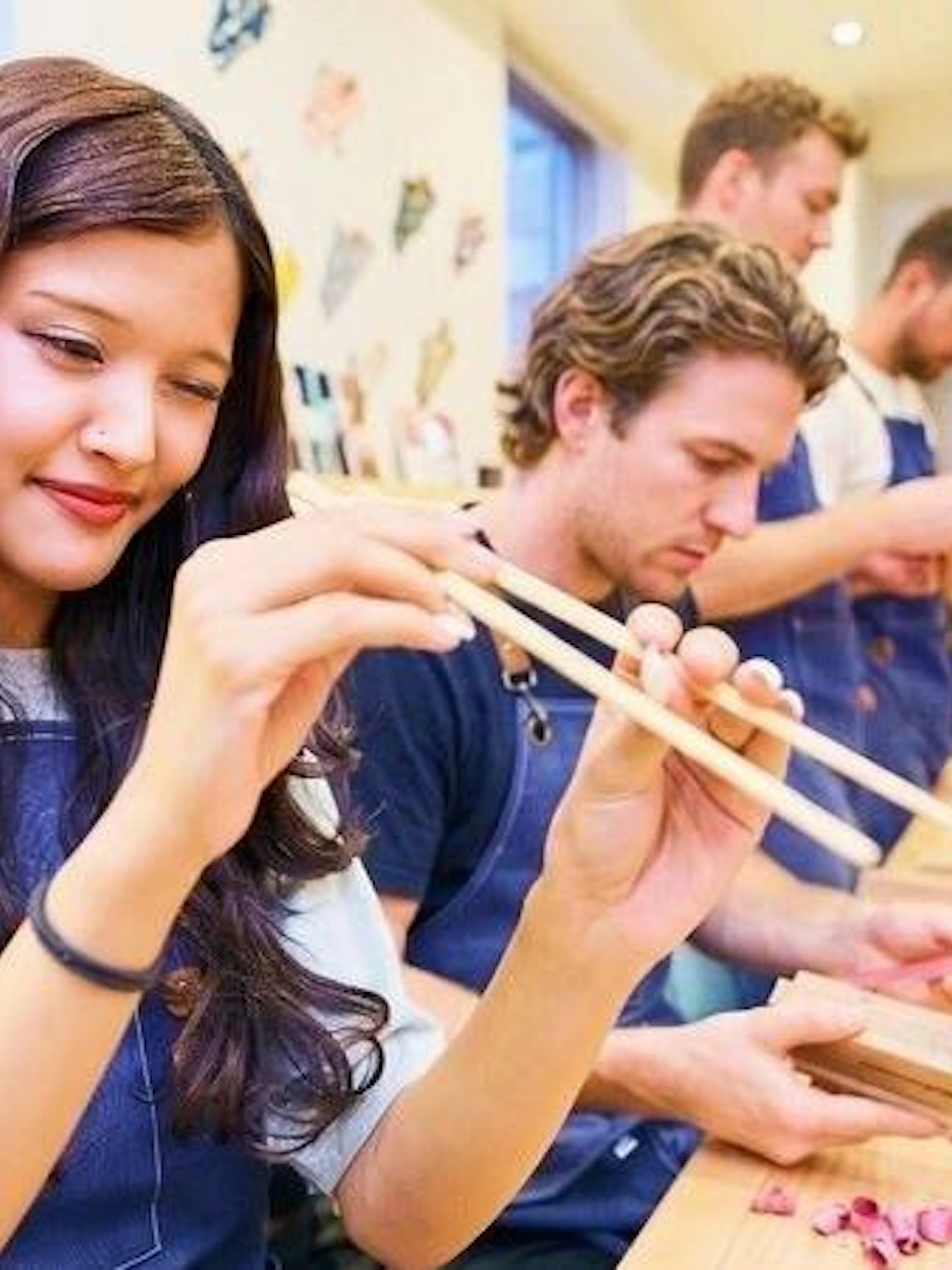 Participants crafting chopsticks at a workshop in Arashiyama, Kyoto.