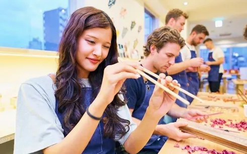 Participants crafting chopsticks at a workshop in Arashiyama, Kyoto.