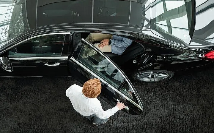 Luxurious car service for Farsha Cafe, Sharm El Sheikh, passenger entering vehicle.