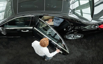 Luxurious car service for Farsha Cafe, Sharm El Sheikh, passenger entering vehicle.