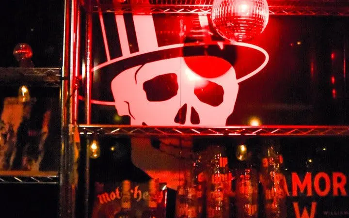 Reykjavik Punk Museum interior with skull mural and red lighting.