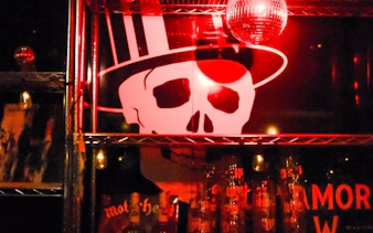 Reykjavik Punk Museum interior with skull mural and red lighting.