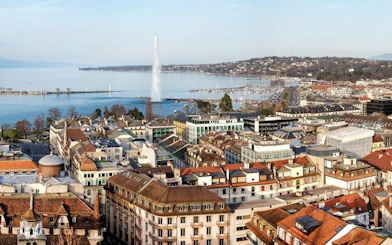 Geneva cityscape with Jet d'Eau fountain and Lake Geneva, view from above.