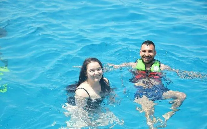 Parasailing participants swimming in Sharm El Sheikh's clear waters.
