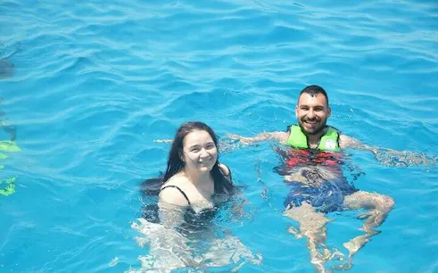 Parasailing participants swimming in Sharm El Sheikh's clear waters.