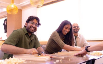 Participants crafting chopsticks at a workshop in Osaka near Shinsaibashi and Dotonbori.