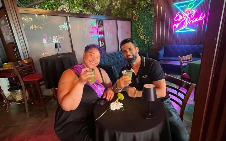 Couple enjoying mojitos at a bar in Little Havana, Miami during a cultural walking tour.