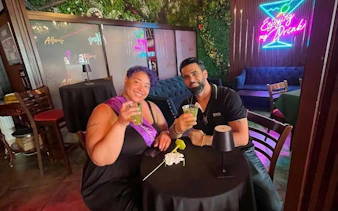 Couple enjoying mojitos at a bar in Little Havana, Miami during a cultural walking tour.