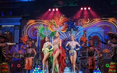 Performers in vibrant costumes on stage at Alcazar Cabaret Show, Pattaya.