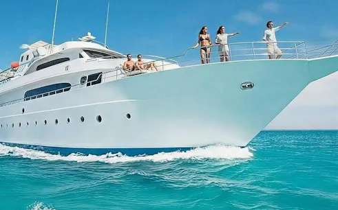 Yacht cruising in Sharm El Sheikh with people enjoying the view, Ras Mohamed National Park tour.