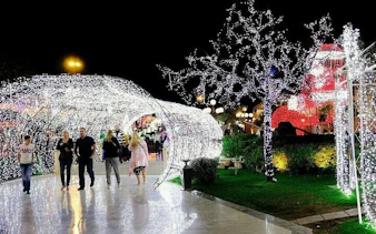 Visitors walking through illuminated tunnel at Soho Square, Sharm El Sheikh.