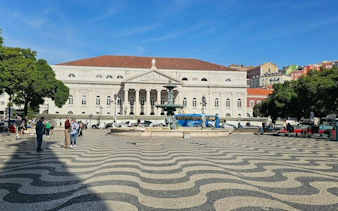 Rossio Square with wave-patterned pavement and fountain, Lisbon Baixa and Chiado walking tour.