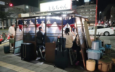 Nakasu food stall with people dining at night in Fukuoka, Japan.