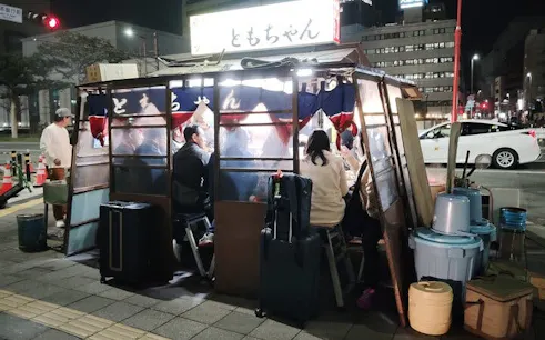 Nakasu food stall with people dining at night in Fukuoka, Japan.