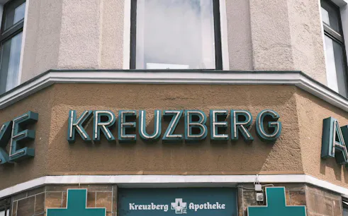 Kreuzberg Apotheke sign on a building corner in Berlin.