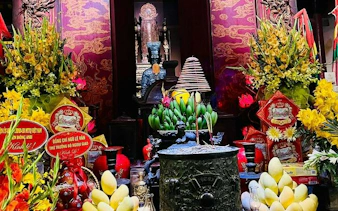 Co Loa Citadel altar with offerings and traditional decorations, Hanoi Vespa tour.