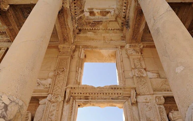 Ancient ruins of Ephesus with detailed stone carvings and columns.