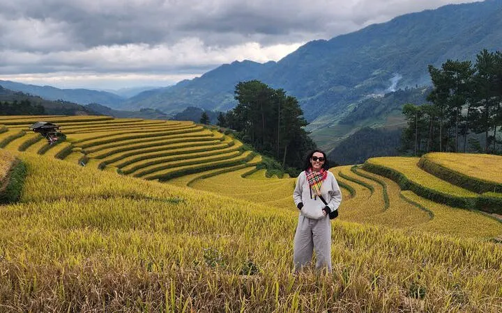 Mu Cang Chai rice terraces with person standing, Northern Vietnam mountain tour.