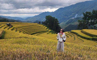 Mu Cang Chai rice terraces with person standing, Northern Vietnam mountain tour.