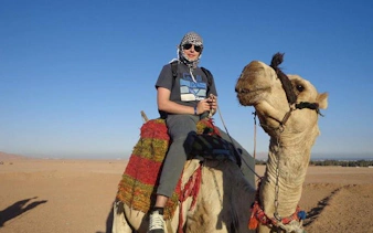 Camel ride experience in Hurghada desert during quad bike safari tour.