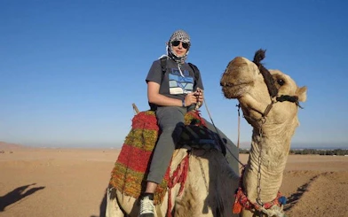 Camel ride experience in Hurghada desert during quad bike safari tour.