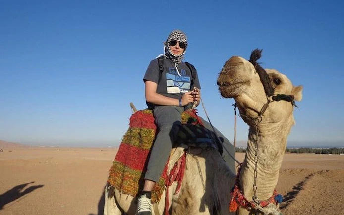Camel ride experience in Hurghada desert during quad bike safari tour.