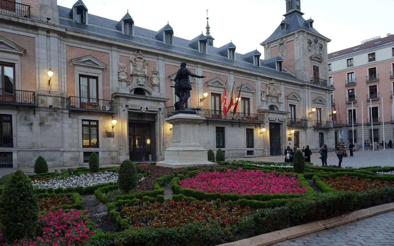 Statue and gardens at Plaza de la Villa in Madrid's historic center.