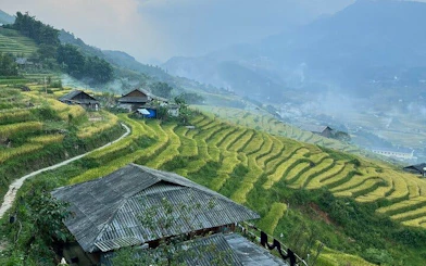 Terraced rice fields and traditional houses in Ta Van village, Sapa, Vietnam.