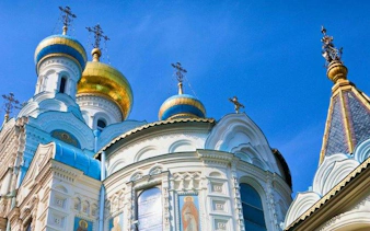 Karlovy Vary Orthodox Church domes under blue sky on self-guided walking tour.