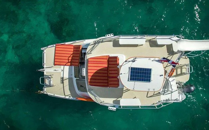 Catamaran on turquoise water, Punta Cana snorkeling cruise.