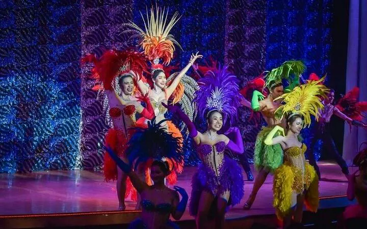Cabaret performers in colorful costumes on stage at Golden Dome, Bangkok.