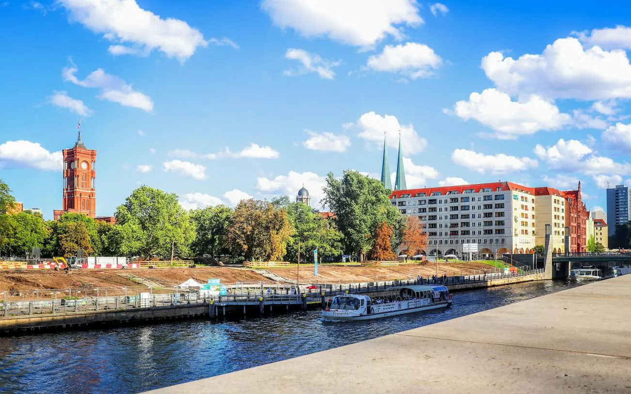 Red Town Hall and Spree River with tour boat in Berlin's Nikolaiviertel.
