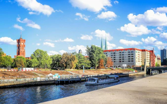 Red Town Hall and Spree River with tour boat in Berlin's Nikolaiviertel.