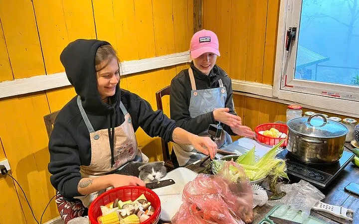 Local chef teaching pho noodle soup cooking class with fresh ingredients.