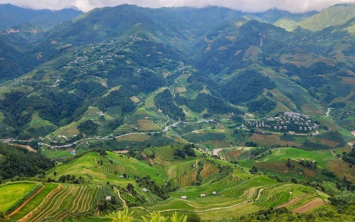 Mu Cang Chai terraced rice fields with mountain backdrop, Vietnam.