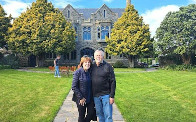 Stone building with arched windows and manicured lawn on Christchurch City Top Sights Half Day Tour.