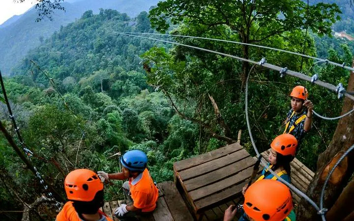 Zipline platform in Chiang Mai jungle with people preparing for descent.