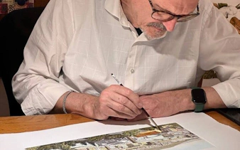 Artisan painting a detailed landscape during Oltrarno tour in Florence.