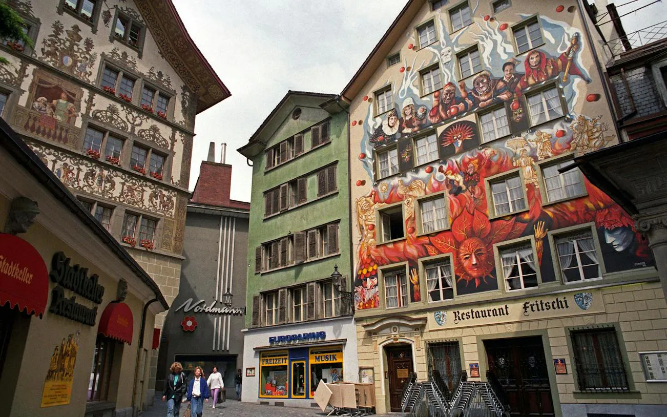 Colorful murals on historic buildings in Lucerne Old Town during a self-guided audio walking tour.