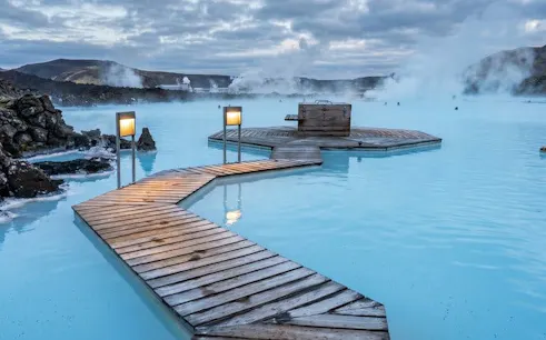 Blue Lagoon geothermal spa with wooden walkways and steam rising, Iceland.